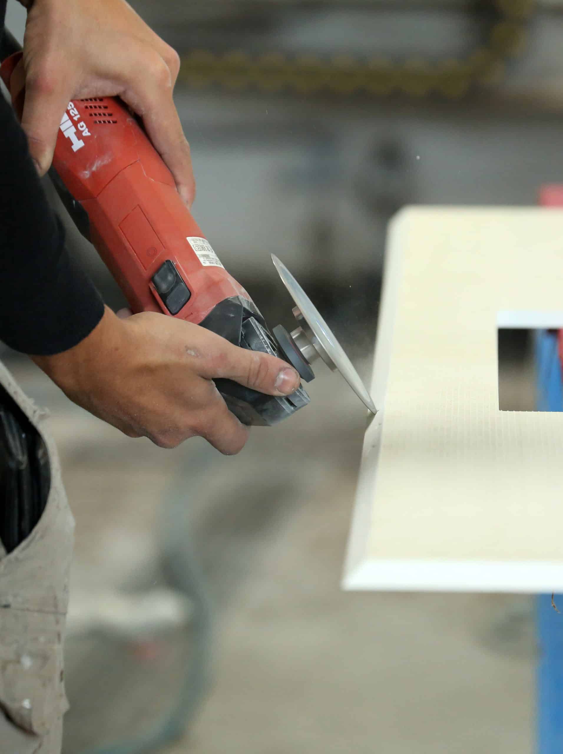 Un artisan qui effectue les finitions d'une plaque de marbre